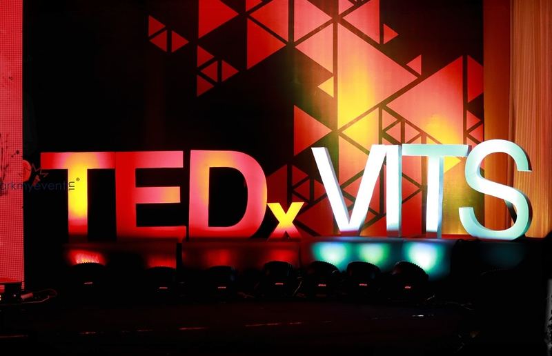 Glowing TEDxVITS letters on stage